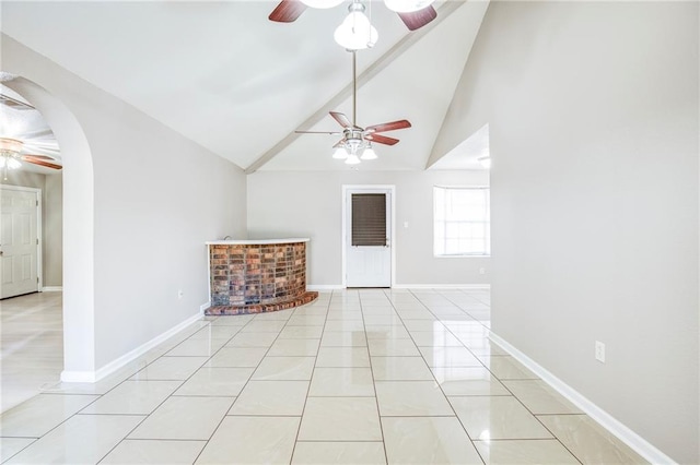 3800 Decomine Dr, Chalmette, LA 70043 - unfurnished living room featuring high vaulted ceiling, baseboards, a ceiling fan, arched walkways, and light tile patterned floors