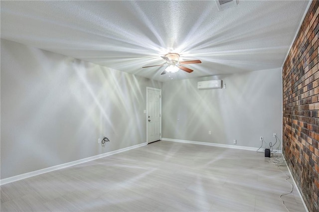 3800 Decomine Dr, Chalmette, LA 70043 - empty room with a wall mounted AC, baseboards, a textured ceiling, visible vents, and a ceiling fan