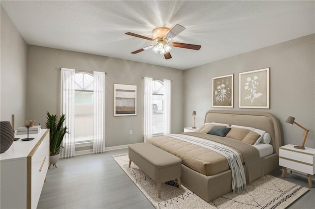 3800 Decomine Dr, Chalmette, LA 70043 - bedroom featuring a ceiling fan, baseboards, and light wood-style floors