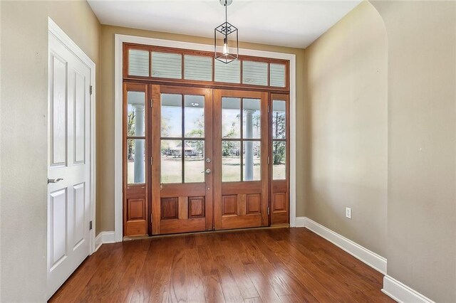 80055 Rollo Rd, Bush, LA 70431 - foyer featuring french doors, dark wood-type flooring, and baseboards