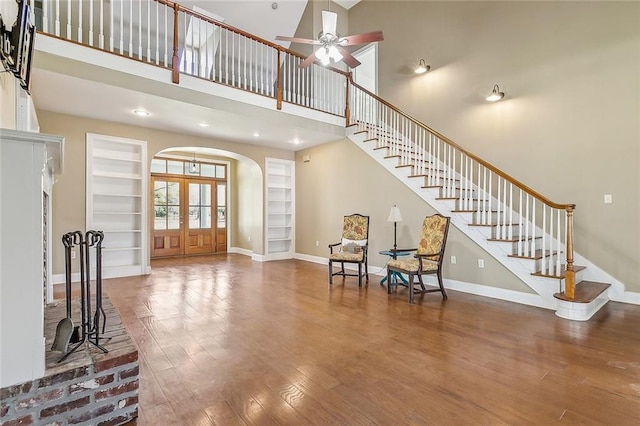 80055 Rollo Rd, Bush, LA 70431 - sitting room featuring baseboards, wood finished floors, arched walkways, and stairway