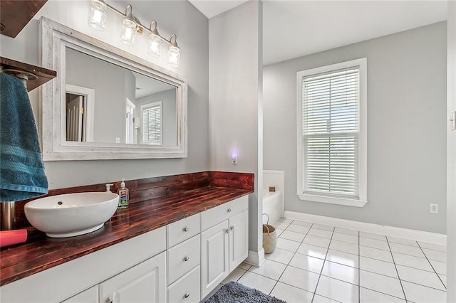 80055 Rollo Rd, Bush, LA 70431 - full bathroom featuring baseboards, tile patterned flooring, vanity, and a garden tub