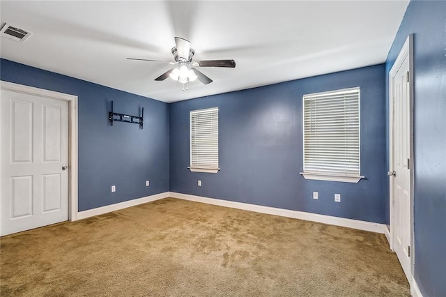 80055 Rollo Rd, Bush, LA 70431 - unfurnished bedroom featuring baseboards, visible vents, carpet flooring, and a ceiling fan