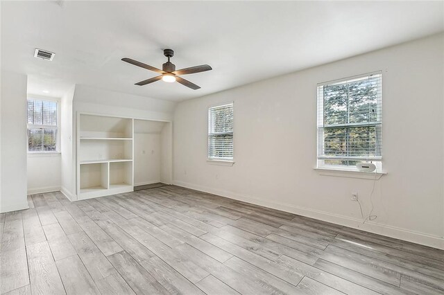 80055 Rollo Rd, Bush, LA 70431 - unfurnished room featuring baseboards, visible vents, ceiling fan, and wood finished floors