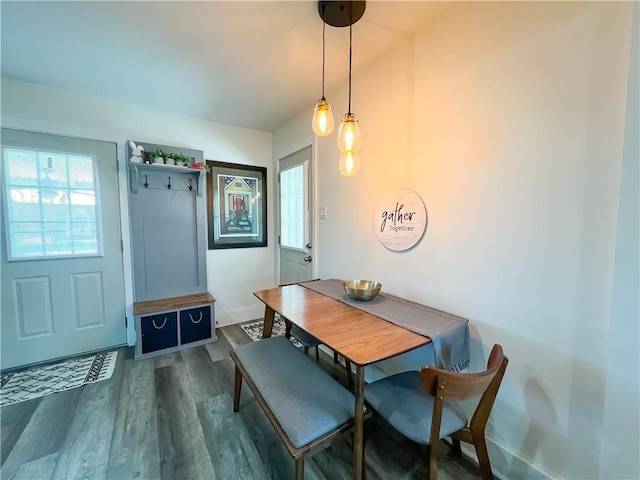 dining area with dark wood finished floors and baseboards