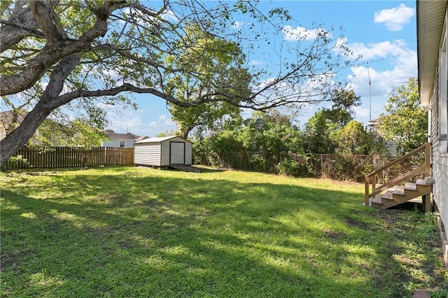 view of yard featuring a fenced backyard, a shed, and an outdoor structure