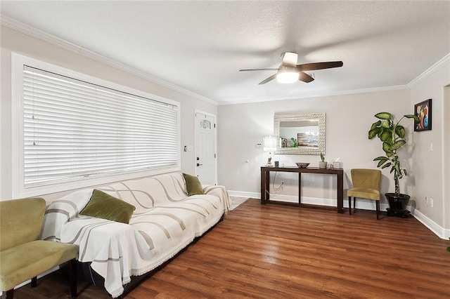 living room with crown molding, wood finished floors, baseboards, and a ceiling fan