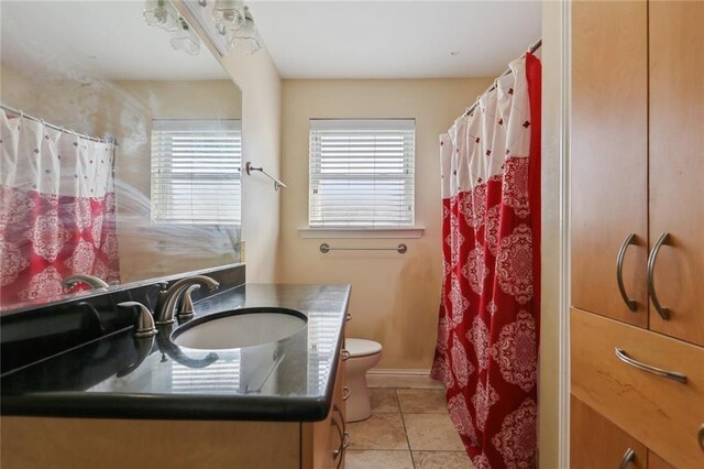 4529 Citrus Dr, New Orleans, LA 70127 - full bath featuring toilet, tile patterned flooring, a shower with curtain, and vanity
