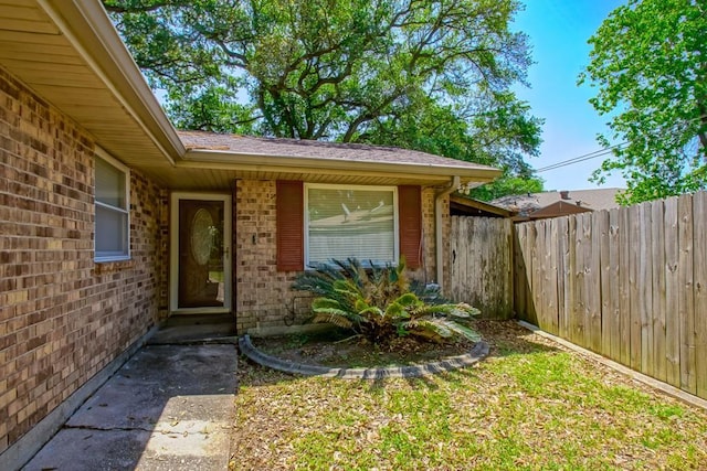 7984 Edgelake Ct, New Orleans, LA 70126 - view of exterior entry featuring brick siding and fence