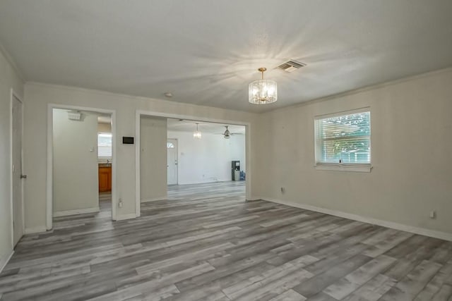 7984 Edgelake Ct, New Orleans, LA 70126 - unfurnished living room featuring crown molding, visible vents, plenty of natural light, and wood finished floors