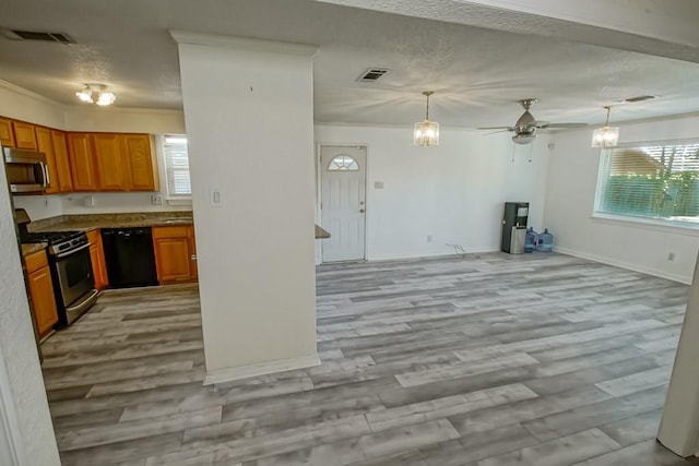7984 Edgelake Ct, New Orleans, LA 70126 - kitchen featuring brown cabinetry, appliances with stainless steel finishes, a ceiling fan, and a healthy amount of sunlight