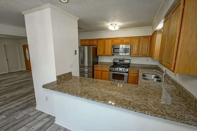 7984 Edgelake Ct, New Orleans, LA 70126 - kitchen featuring light wood-style floors, ornamental molding, stone countertops, a sink, and stainless steel appliances
