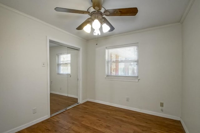 7984 Edgelake Ct, New Orleans, LA 70126 - unfurnished bedroom with ornamental molding, baseboards, a closet, and wood finished floors