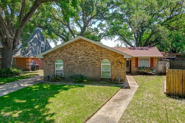 7984 Edgelake Ct, New Orleans, LA 70126 - view of front of house with a front yard, brick siding, and fence