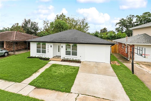 view of front of home with a front yard, fence, brick siding, driveway, and roof with shingles