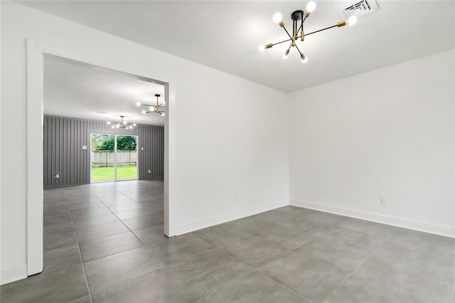 4904 Argonne St, Metairie, LA 70001 - unfurnished room with a chandelier, baseboards, and concrete flooring