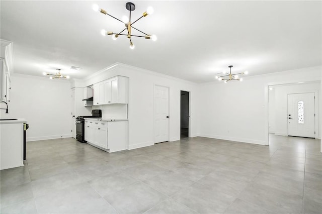 4904 Argonne St, Metairie, LA 70001 - unfurnished living room featuring a chandelier, ornamental molding, baseboards, and a sink