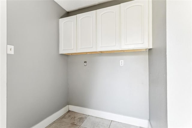 238 Blue Crane 1 Dr, Slidell, LA 70461 - laundry area with baseboards, cabinet space, and light tile patterned floors