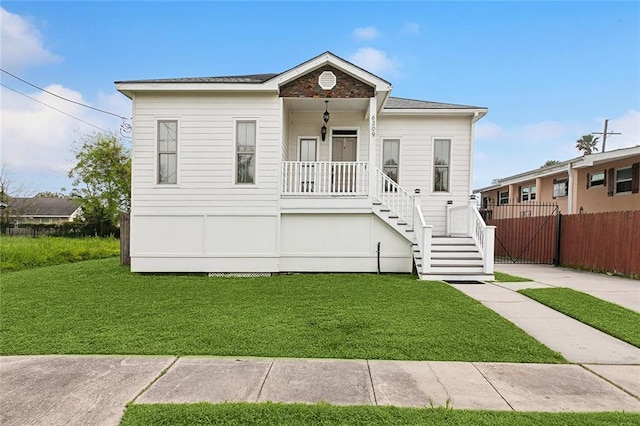 6309 Debore Dr, New Orleans, LA 70126 - view of front of house featuring a front yard, fence, and stairs