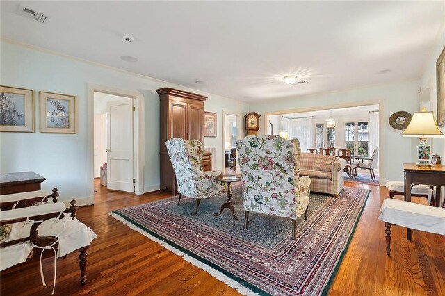 107 Stella St, Metairie, LA 70005 - living area featuring baseboards, dark wood finished floors, and ornamental molding