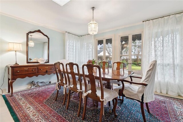 107 Stella St, Metairie, LA 70005 - dining space featuring a chandelier, french doors, and ornamental molding