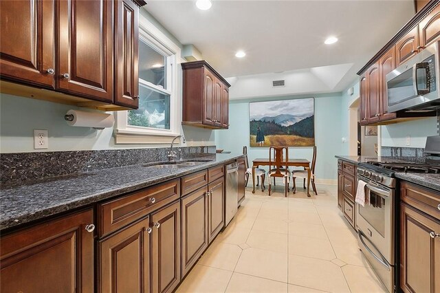 107 Stella St, Metairie, LA 70005 - kitchen with appliances with stainless steel finishes, a sink, dark stone countertops, light tile patterned flooring, and recessed lighting