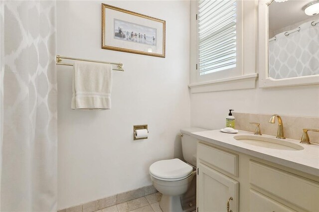107 Stella St, Metairie, LA 70005 - bathroom featuring toilet, vanity, tile patterned flooring, baseboards, and a shower with shower curtain