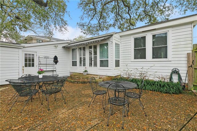 107 Stella St, Metairie, LA 70005 - back of house featuring outdoor dining space, a patio area, and fence