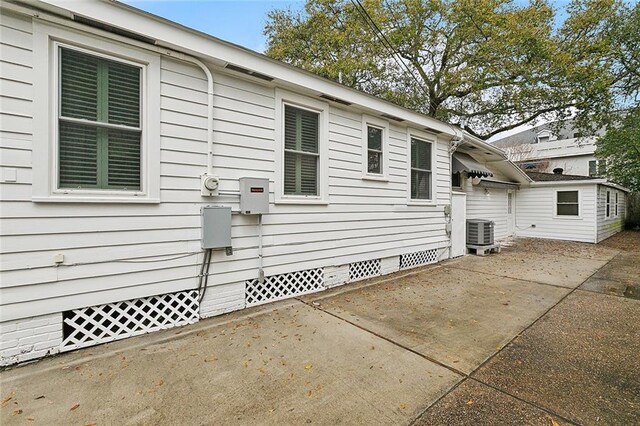 107 Stella St, Metairie, LA 70005 - view of side of home with crawl space, central AC unit, and a patio