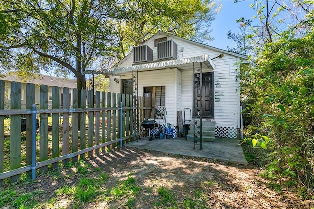 902931 Hickory St, New Orleans, LA 70118 - back of house with fence, cooling unit, and a patio