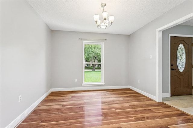 803 Lake Dcote Ct, Slidell, LA 70461 - foyer entrance featuring a chandelier, light wood-type flooring, and a textured ceiling