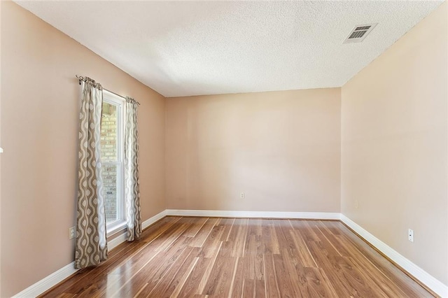 803 Lake Dcote Ct, Slidell, LA 70461 - spare room featuring light wood finished floors, baseboards, and a textured ceiling