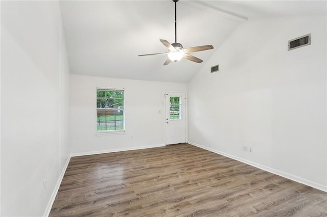 1465 Sunset Dr, Slidell, LA 70460 - empty room with ceiling fan, wood finished floors, baseboards, beam ceiling, and high vaulted ceiling