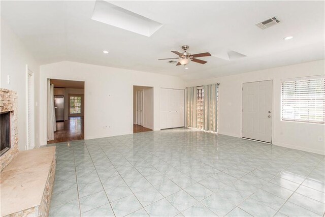 17168 E Little Italy Rd, Hammond, LA 70403 - unfurnished living room featuring a fireplace, visible vents, vaulted ceiling, and a ceiling fan
