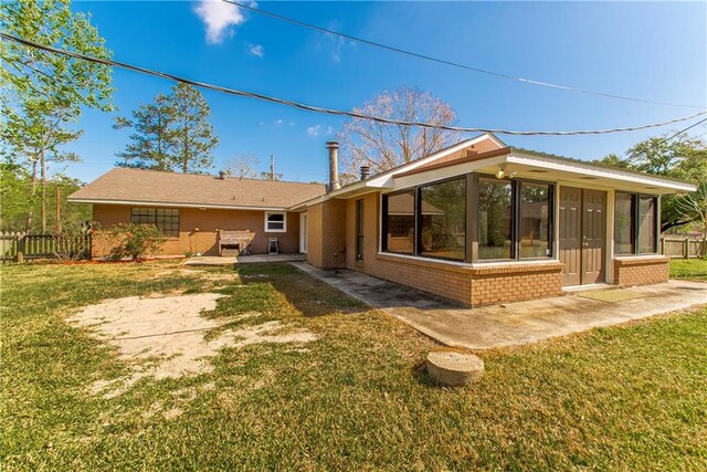 17168 E Little Italy Rd, Hammond, LA 70403 - rear view of property with a patio, a sunroom, brick siding, and a yard