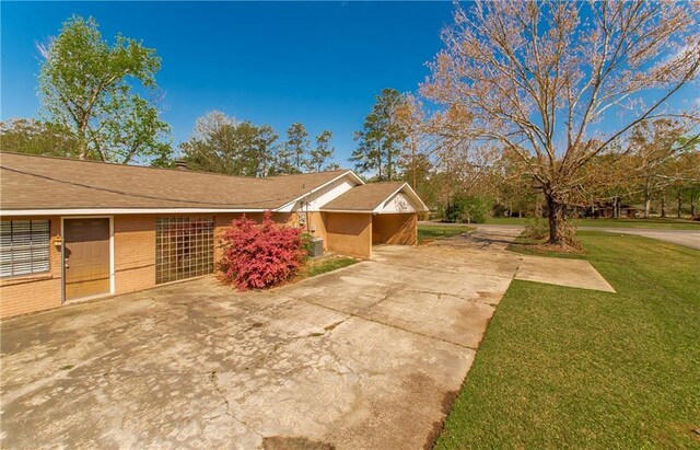 17168 E Little Italy Rd, Hammond, LA 70403 - view of side of property featuring a lawn, driveway, and brick siding