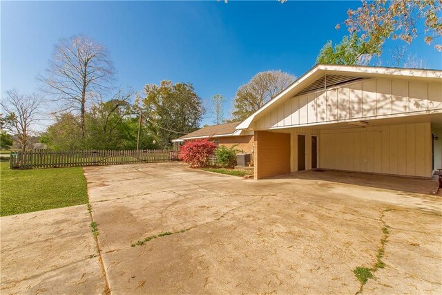 17168 E Little Italy Rd, Hammond, LA 70403 - view of home's exterior with driveway, a carport, and fence