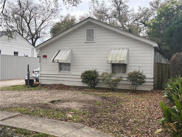 view of side of property featuring fence