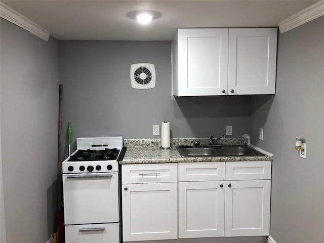 kitchen featuring white cabinets, a sink, white gas stove, and visible vents