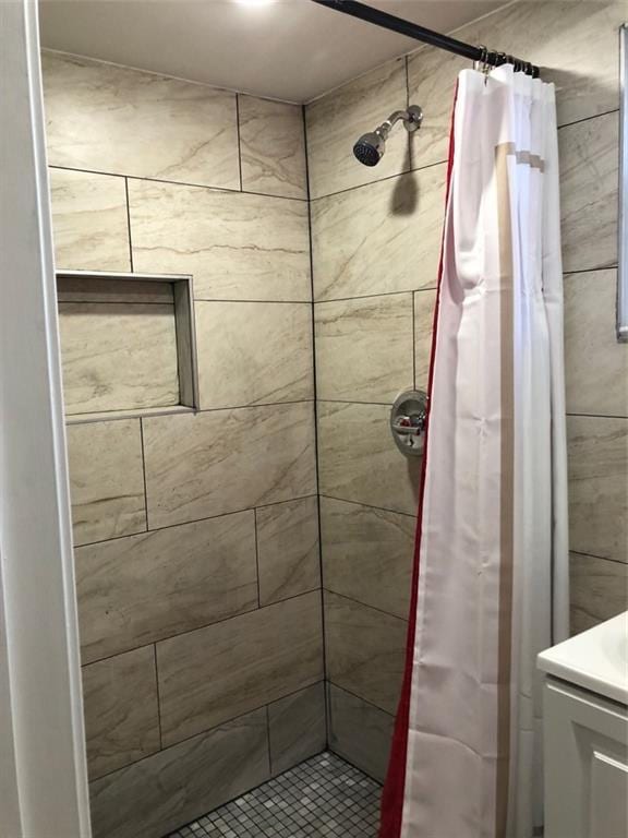 full bathroom featuring a shower stall and vanity