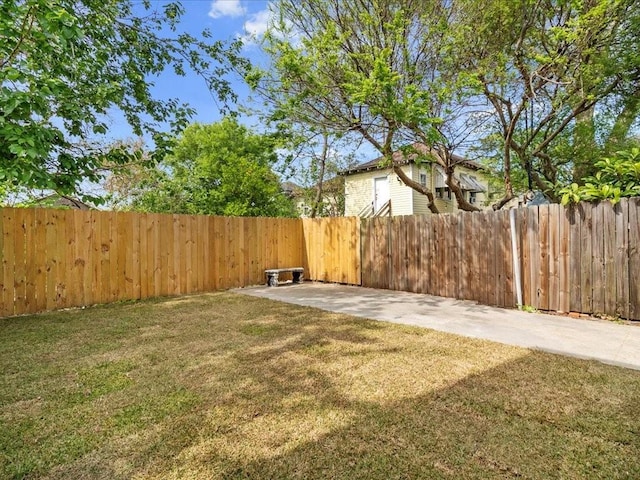 view of yard with a fenced backyard and a patio