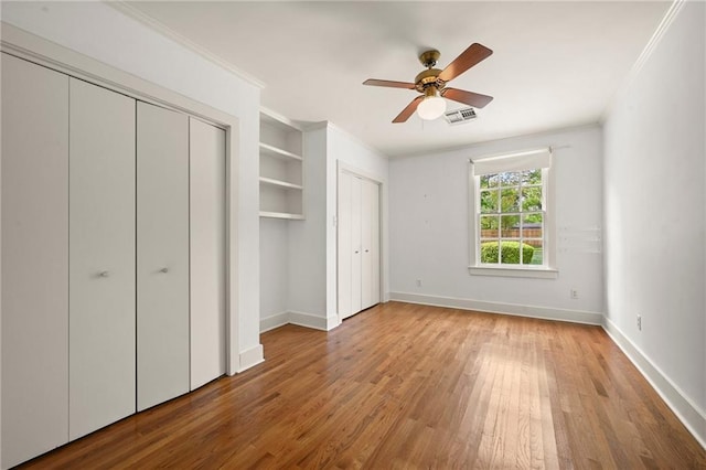 2108 Cherrydale Ave, Baton Rouge, LA 70808 - unfurnished bedroom with wood finished floors, ornamental molding, baseboards, and visible vents