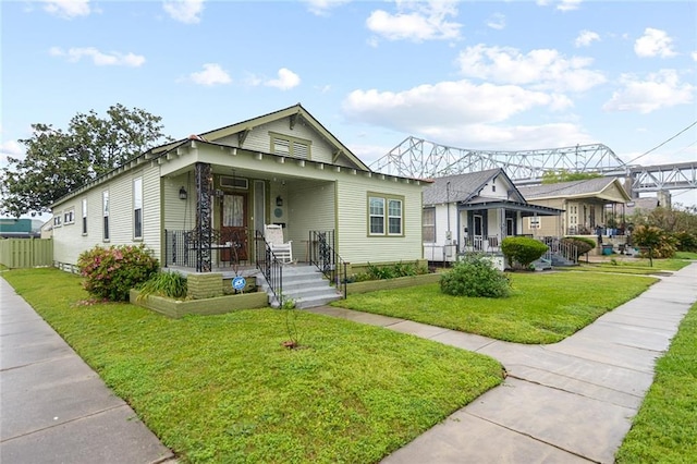 bungalow featuring a porch and a front yard