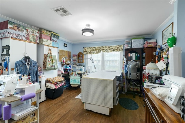 interior space with wood finished floors, visible vents, and crown molding