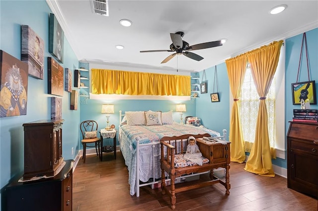 bedroom with wood finished floors, visible vents, recessed lighting, and crown molding