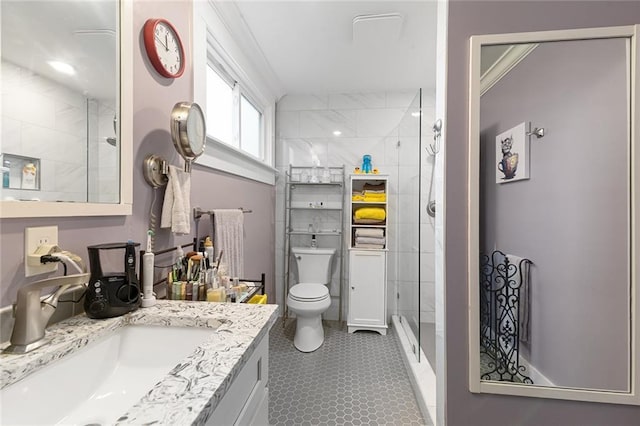 full bathroom featuring a shower stall, toilet, and vanity