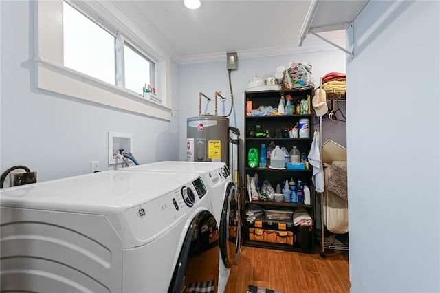 washroom featuring washing machine and clothes dryer, crown molding, wood finished floors, electric water heater, and laundry area