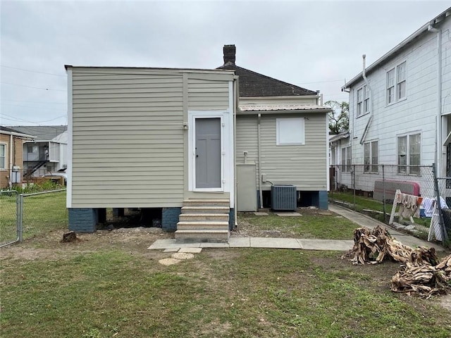 3321 Baronne St, New Orleans, LA 70113 - rear view of house featuring a lawn, entry steps, and fence