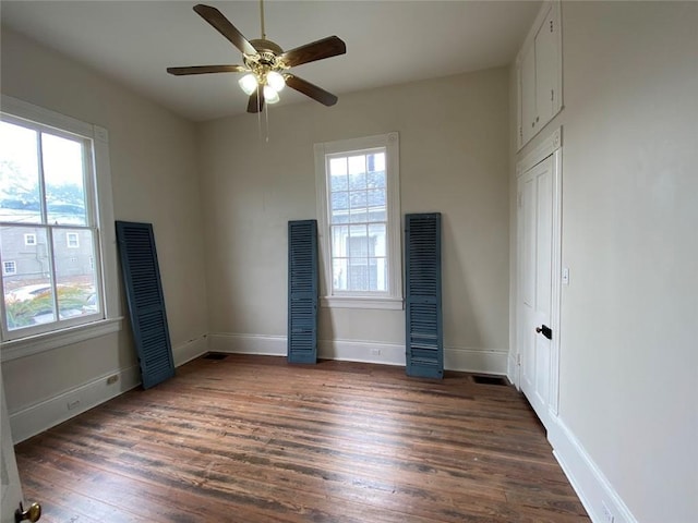 3321 Baronne St, New Orleans, LA 70113 - unfurnished bedroom featuring a ceiling fan, baseboards, and wood finished floors