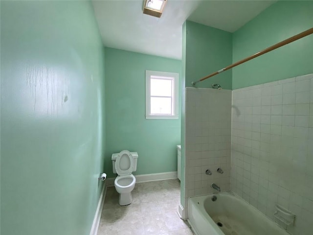 3321 Baronne St, New Orleans, LA 70113 - bathroom featuring toilet, baseboards, and bathtub / shower combination